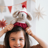 House of Holabox and the little dog laughed mini Christmas Theodora rabbit soft toy held by a child