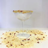 House of Holabox The Peel Thing Citrus Pash cocktail sugar rim on a ribbed glass with dried orange and flower petals
