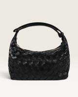 House of Holabox Cleo black woven vegan leather handbag with an adjustable top handle and a zip closure.