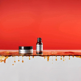 House of Holabox The Groomed Man Co Cool Cola beard oil and balm set on a surface with dripping cola-colored liquid.