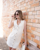House of Holabox Sabine denim vest dress in cream cotton with contrast stitching, patch pockets, and button front.