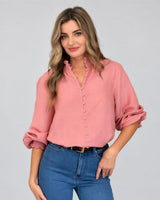 Model wearing House of Holabox Lani shirred blouse in dusty rose with smocked collar, cuffs, and blouson sleeves.