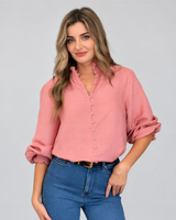 Model wearing House of Holabox Lani shirred blouse in dusty rose with smocked collar, cuffs, and blouson sleeves.