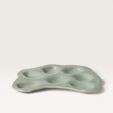 House of Holabox Ecology Selvedge stoneware oyster plate in Mine green with a glossy reactive glaze and ridged texture.