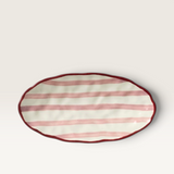 House of Holabox Ecology Porto Sable oval stoneware platter in raspberry with handpainted red stripes and maroon rim.
