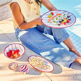 House of Holabox Ecology Porto Sable oval stoneware platter in raspberry with handpainted red stripes by a pool