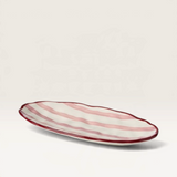 House of Holabox Ecology Porto Sable oval stoneware platter in raspberry with handpainted red stripes and dimpled rim
