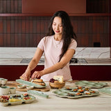 House of Holabox Ecology Selvedge stoneware oyster plate in Mine green with textured ridged surface on a dining table