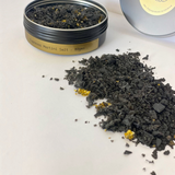 House of Holabox The Peel Thing black and gold espresso martini cocktail salt in a black tin on a white surface.