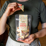 House of Holabox Cloudy Confections triangle marshmallows covered in rainbow sprinkles held in a resealable pouch.