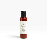 House of Holabox Finn's Kitchen chunky tomato ketchup in a glass bottle with a black lid on a white background