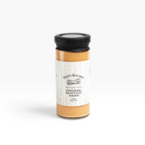 House of Holabox Finn's Kitchen creamy seafood sauce in a glass jar with a black lid on a white background