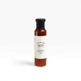 House of Holabox Finns Kitchen chunky sweet chilli sauce in a glass bottle with a black cap on a white background