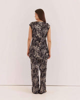 House of Holabox Fiora tunic top in black with a white floral print, featuring a waist tie and boat neckline.