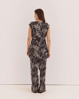 House of Holabox Fiora tunic top in black with a white floral print, featuring a waist tie and boat neckline.