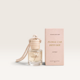 House of Holabox Soaked Body Bar floral car diffuser in Retreat scent with wooden lid and hanging rope next to box.