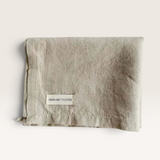 House of Holabox Mama and Tochter folded natural beige French linen tea towel with a branded fabric label.