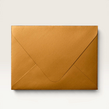 House of Holabox metallic gold envelope for the Welcome Little One foil greeting card on a beige background