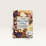 House of Holabox The Grazing Table cookbook featuring a vibrant charcuterie and fruit board on the cover