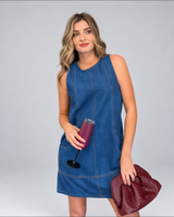House of Holabox Hart denim shift dress in classic blue with crew neck, front pockets, and seam detailing on a model