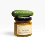 House of Holabox Women’s Work Hot Dog Relish in a small glass jar topped with a fresh green cucumber