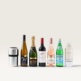 House of Holabox Huski stainless steel wine cooler next to a selection of wine, champagne, and sparkling water bottles