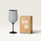 House of Holabox Huski Wine Tumbler 2.0 in stone grey with a black detachable stem and lid next to its product box.
