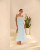 Model wearing House of Holabox icy blue sheer floral tiered midi dress with straight neckline and adjustable straps