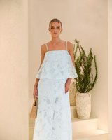 House of Holabox icy blue sheer floral tiered midi dress with straight neckline and adjustable straps on a model