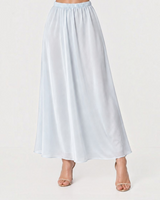 House of Holabox icy blue midi skirt with a flowing silhouette and sheer finish worn with neutral heels
