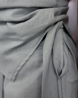 Close-up of the House of Holabox Imogen Pant Set featuring a grey cotton-linen blend fabric with a functional wrap tie.