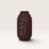 House of Holabox Ivy Ila Japanese Honeysuckle sugar body polish in a dark brown 200ml squeeze bottle.