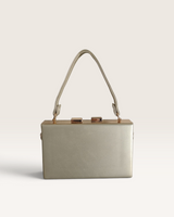 House of Holabox Izoa Brianna gold hard-frame clutch with a structured silhouette and top clasp closure.