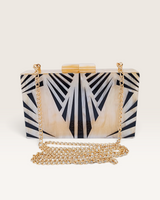 House of Holabox Izoa Krista clutch in cream marble acrylic with graphic black stripes and a detachable gold chain strap.