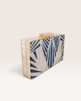House of Holabox Izoa Krista clutch in cream marble acrylic with graphic black stripes and gold top clasp