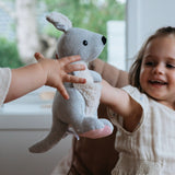 House of Holabox and the little dog laughed kangaroo soft toy with pink corduroy accents held by a happy child