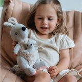 A young girl holding an and the little dog laughed Glenda's younger sister kangaroo soft toy with a removable joey.