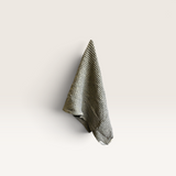 House of Holabox organic cotton waffle hand towel in khaki hanging on a wall