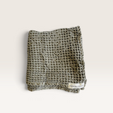 House of Holabox Mama and Tochter khaki organic cotton waffle hand towel with a rustic stone-washed texture.