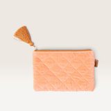 House of Holabox Kip and Co quilted melon velvet cosmetics purse with a decorative tassel and zip closure.