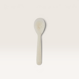House of Holabox Kip resin spoon in a creamy off-white marble finish, perfect for serving dips and cheese platters.