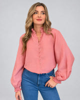 House of Holabox Lani shirred blouse in dusty rose with smocked collar, button front, and blouson sleeves on a model.