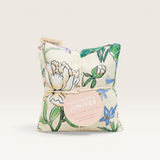 House of Holabox Dancing with Juniper floral print organic lavender and wheat heat pillow with a round product tag.