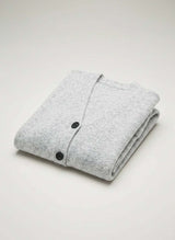 House of Holabox Lee Longline Cardi in soft grey, made from polyester, acrylic, nylon, wool, and elastane. Features black buttons and a longline silhouette.