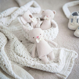 House of Holabox Alimrose linen mini koala and bunny rattles with embroidered faces and ivory bows on a knit blanket