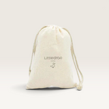 House of Holabox Little Drop bathtime book in a natural beige cotton drawstring storage bag with logo print