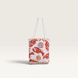 House of Holabox microfibre beach towel in a lobster print storage bag with white rope handles.
