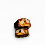 House of Holabox Maple Macadamia Caramel chocolate twin pack cut in half showing chewy caramel and roasted macadamias