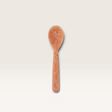 House of Holabox Kip resin spoon in a marbled peach tone, perfect for serving dips and cheese platters.