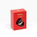 House of Holabox Sweeta milk chocolate licorice in a vibrant red box with a die-cut window showing the treats inside.